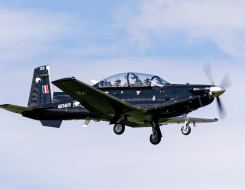 A Royal New Zealand Air Force T-6C Texan II aircraft flying with two people in the aircraft