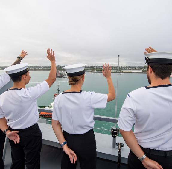 Royal New Zealand Navy sailors wave from HMNZS Aotearoa arriving into New Plymouth. 