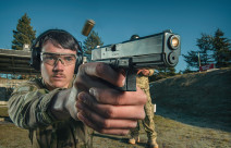 A New Zealand Army soldier fires a Glock G17 Gen 4 with another soldier standing behind them. 