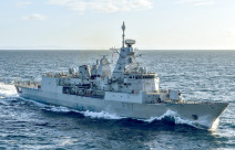 HMNZS Te Kaha sails on the ocean on a sunny day