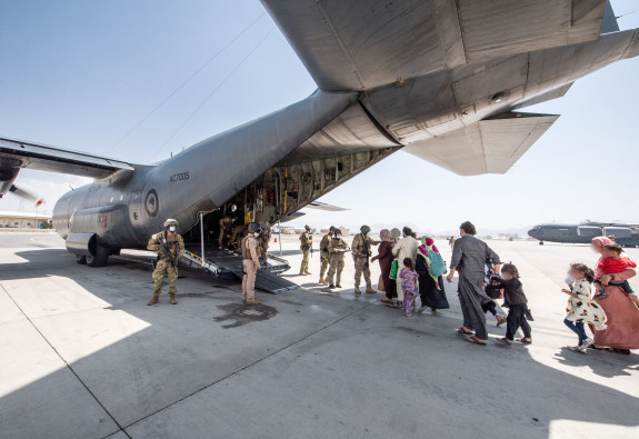 Evacuees board the Hercules aircraft at Hamid Karzai International Airport in Kabul