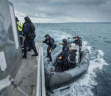 Members of the Deployable Boarding Team board custom's vessel Hawk V in the Hauraki Gulf.