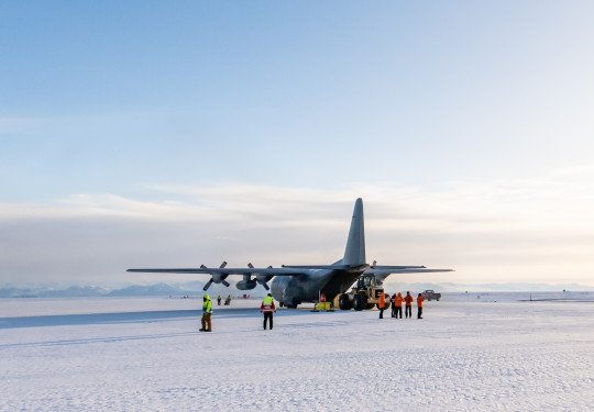 A Royal New Zealand Air Force C-130 Hercules in Antarctica sitting on the ice. 