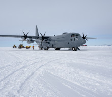 Large grey aircraft parked on the ice in Antarctica