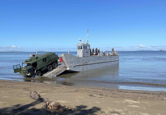 A Pinzgauer vehicle drives off a landing craft on to Lomolomo during Operation Mahi Tah