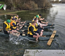 Two groups row across the lake