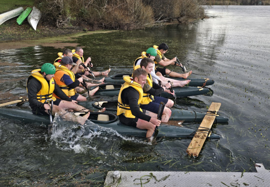 Two groups row across the lake