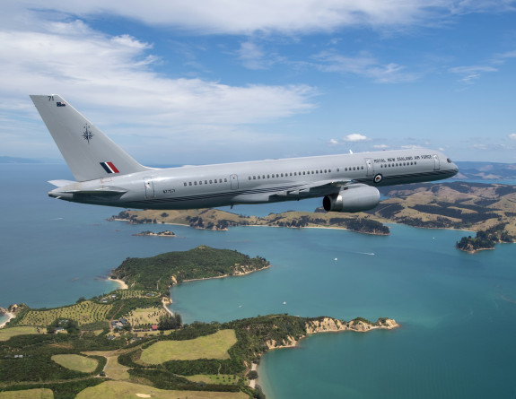 A Boeing aircraft flying over Auckland on a stunning day 