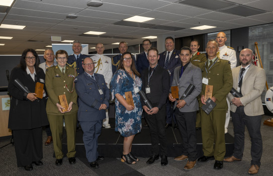 Award winners holding awards with NZDF leadership.