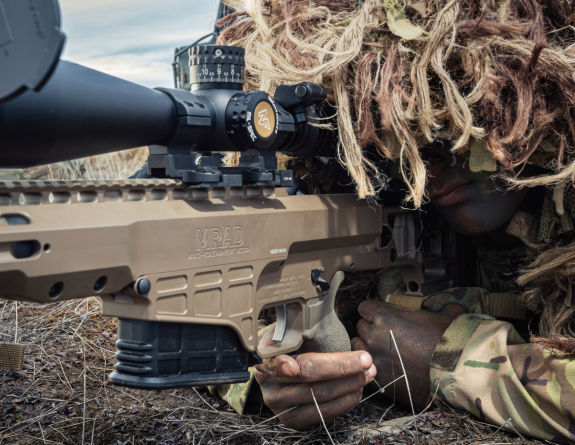 A close up shot of a New Zealand Army soldier and a MRAD Sniper Rifle